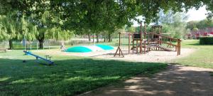 a park with a playground with a swing set at Green Hills home in Ewijk
