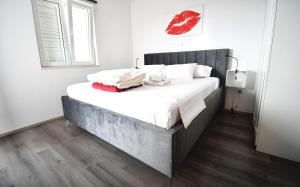 a bedroom with a large bed with white sheets and pillows at Dubrovnik Icy Guest House in Dubrovnik