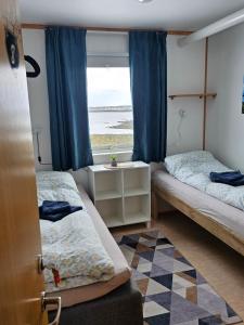 Postel nebo postele na pokoji v ubytování Gamvik brakkebo as