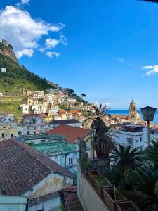 a view of a city with houses and the ocean at La Casa del Capitano in Amalfi +35 photos