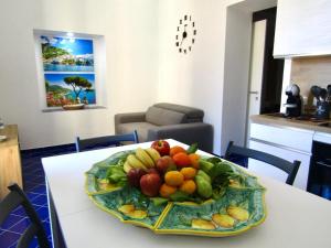 a plate of fruit on a table in a room at La Casa del Capitano in Amalfi