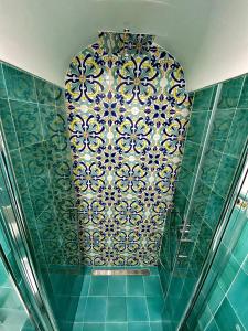 a room with a tile ceiling with a pattern on the wall at La Casa del Capitano in Amalfi +41 photos