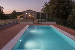 a swimming pool in front of a house at Cal Sicull in Santa María de Marlés