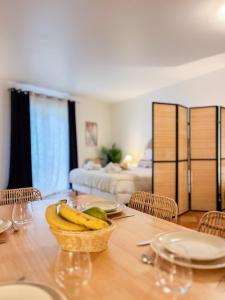 a dining room with a table with bananas on it at Place des Lices - NK in Saint-Tropez