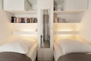 een slaapkamer met een bed en een boekenplank bij Strandappartements am Leuchtturmweg Baltic-View in Kellenhusen