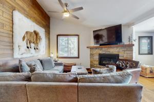 a living room with a couch and a fireplace at Snowmass Village 95 in Snowmass Village