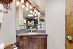 a bathroom with a sink and a mirror at Snowmass Village 95 in Snowmass Village +13 photos