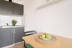 a kitchen with a table with a plate of apples on it at Blankwasserweg 131 Lensterstrand Oase Bungalow 5 in Lenste