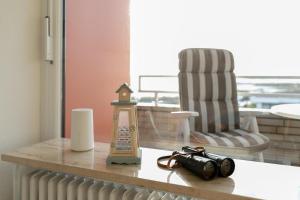 a table with a camera on a counter with a chair at Strandidyll- Wohnung 41 in Grömitz