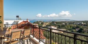 a balcony with a table and chairs and a view at Sunlit sea view apartments in Stalos