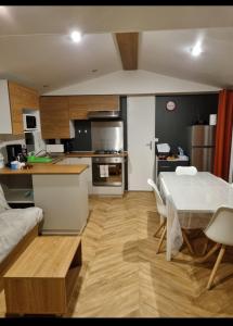 a kitchen and living room with a table and a dining room at mobil home in La Celle-sous-Gouzon
