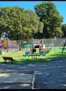 a small plane on a playground with a bench at mobil home in La Celle-sous-Gouzon