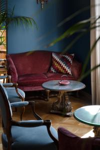 a living room with a red couch and a table at Palace Hotel in Viareggio