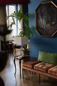 a living room with a couch and a painting on the wall at Palace Hotel in Viareggio
