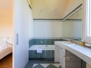 a bathroom with a tub and a sink and a bed at Maison Bretonne Madame est Servie 4 in Perros-Guirec +20 photos