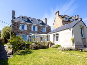 a large brick house with a yard at Maison Bretonne Madame est Servie 4 in Perros-Guirec