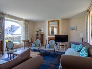 a living room with a couch and a tv at Maison Bretonne Madame est Servie 4 in Perros-Guirec