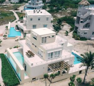 an aerial view of a white house with a swimming pool at Waterfront 6 Br Villa W Private Plunge Pool in San Pedro