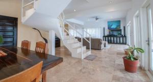 a living room with a staircase in a house at Waterfront 6 Br Villa W Private Plunge Pool in San Pedro