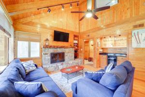 a living room with a blue couch and a fireplace at Walk to Ski Slopes Sugar Mountain Unit with Balcony in Sugar Mountain