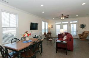 a living room with a red couch and a table at Burpeau Unit A by Bryant Real Estate in Kure Beach
