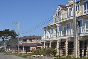 a row of houses on the side of a street at The Oceanfront Hotel on MiramarBeach HMB in Half Moon Bay