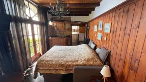 a bedroom with a bed in a room with wooden walls at VillaMarinaPigra Lake View Apartments in Pigra