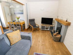 a living room with a couch and a fireplace at 3 The Barn in Haverfordwest