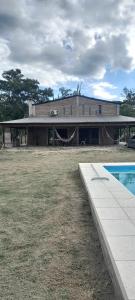 a building with a swimming pool in front of it at Sueño Cumplido in Goya