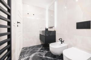 a bathroom with a white toilet and a sink at Easylife - Milano - Medici 5 P2D - Duomo in Milan +31 photos