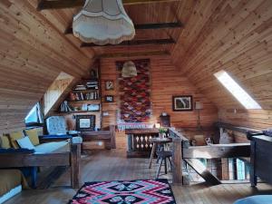 an attic room with wooden walls and wooden ceilings at Breb s Cosy Barn in Breb