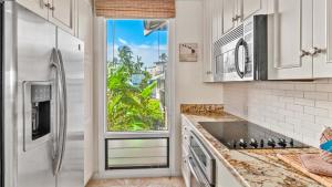a kitchen with a stainless steel refrigerator and a window at Kapalua Bay Villa 35B2 in Kapalua