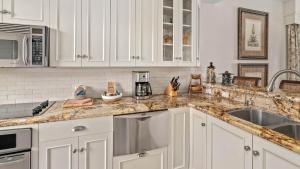 a kitchen with white cabinets and a sink at Kapalua Bay Villa 35B2 in Kapalua +38 photos