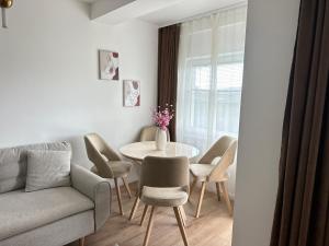 a living room with a table and chairs and a couch at Tivat Apartment in Tivat