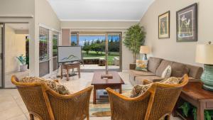 a living room with a couch and a tv at Kapalua Golf Villa 15P78 in Kapalua