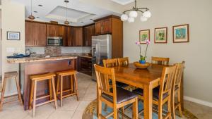 a kitchen with a wooden table and a refrigerator at Kapalua Golf Villa 15P78 in Kapalua +30 photos
