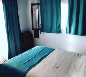 Postel nebo postele na pokoji v ubytování Algarrobo Cabaña a 2 cuadras Playa El Canelo+Wifi