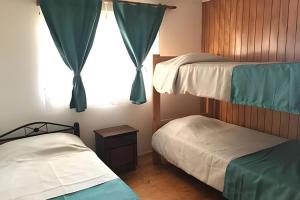 Postel nebo postele na pokoji v ubytování Algarrobo Cabaña a 2 cuadras Playa El Canelo+Wifi