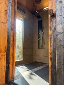 a bathroom with a shower with a window and a shower at Bulle transparente in Champfromier