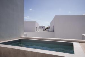 a swimming pool on the balcony of a house at Poema Antiparos in Antiparos