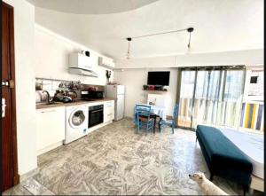 a kitchen and dining room with a dog in a room at Studio Palm Beach Cannes in Cannes
