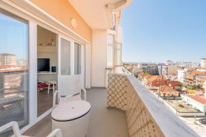 a balcony with a view of a city at GuestReady - Seaview in Costa da Caparica in Costa da Caparica