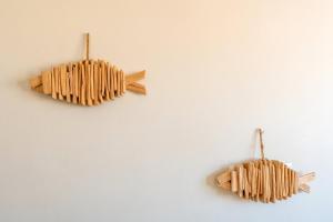 two pieces of wood hanging on a wall at GuestReady - Seaview in Costa da Caparica in Costa da Caparica