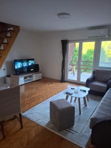 a living room with a couch and a table at Vila Tea Borsko Jezero in Bor