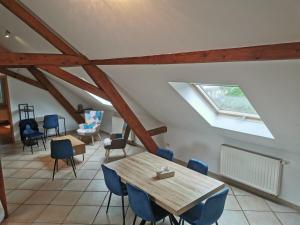 a room with a table and chairs in a attic at Le Bretzel in Zillisheim