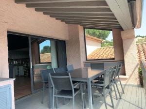 a dining table and chairs on a patio at Vivre Sainte-Maxime à pieds in Sainte-Maxime
