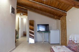 a living room with a television and a couch at calmia in Lefkada