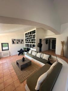 a large living room with a couch and a table at Vivre Sainte-Maxime à pieds in Sainte-Maxime