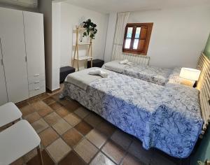 a bedroom with two beds and a table and chairs at MEQUEDO LAS CAÑAS Alcañiz in Alcañiz +51 photos