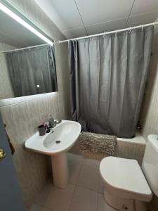 a bathroom with a sink and a toilet and a shower at Appartement proche Port dans le Centre ville in Girona +7 photos